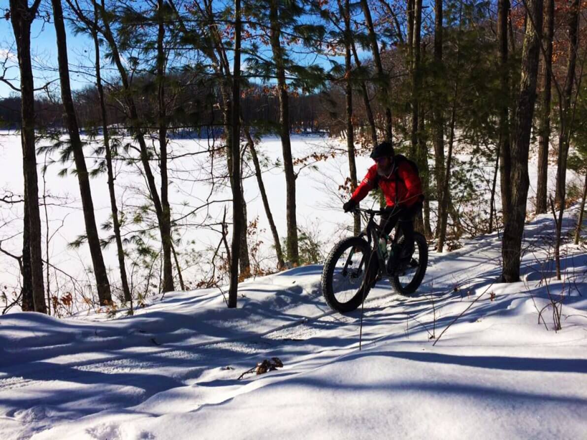 A person rides a fat bike on the Hickory Ridge Trails, which are funded in part by the Knowles-Nelson Stewardship Program.