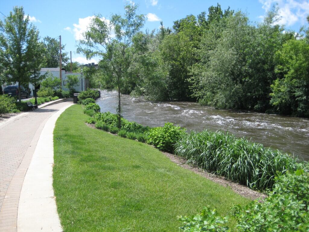 The Fox River in the Fox Valley with the river flowing on the right next to a paved path.