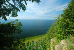 A bluff in Door County with a wooded area leading down to a large lake.