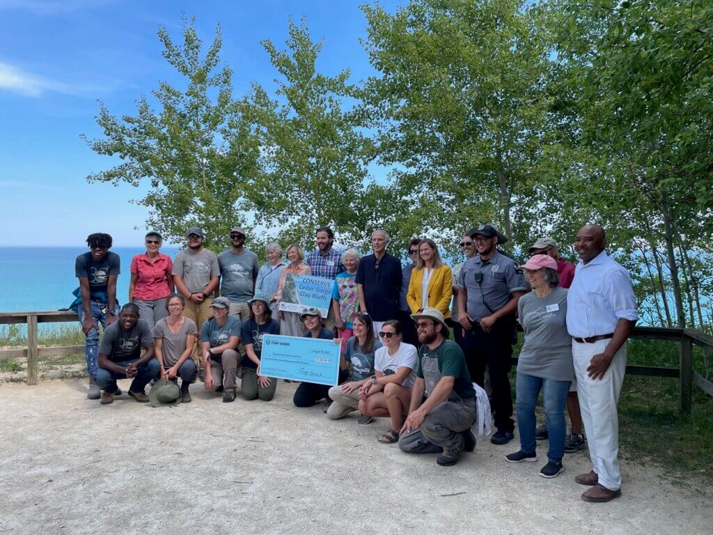 Knowles-Nelson Stewardship Program - A group of people surround an oversized check for $2.3 million dollars for funding the Cedar Gorge-Clay Bluffs project