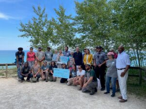 Knowles-Nelson Stewardship Program - A group of people surround an oversized check for $2.3 million dollars for funding the Cedar Gorge-Clay Bluffs project