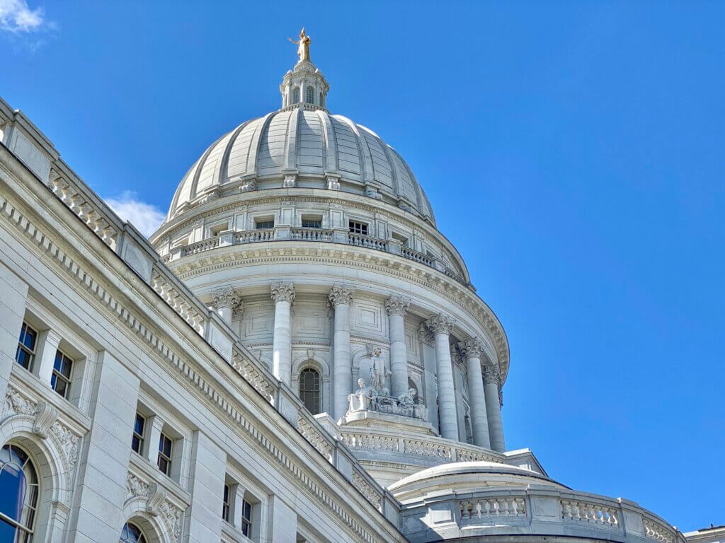 Wisconsin state capitol building against blue sky.
