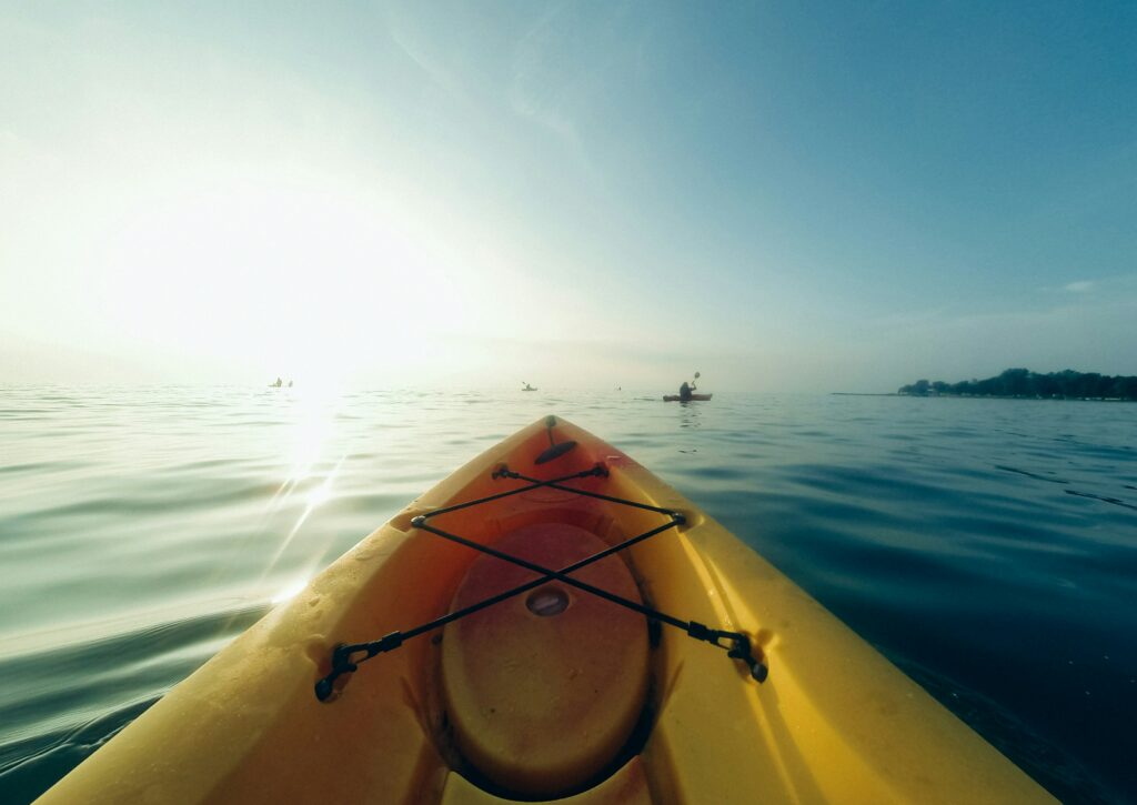 Bow of a yellow kayak in the water.